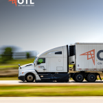 Semi-truck transporting freight on a highway representing warehouse logistics and supply chain operations.